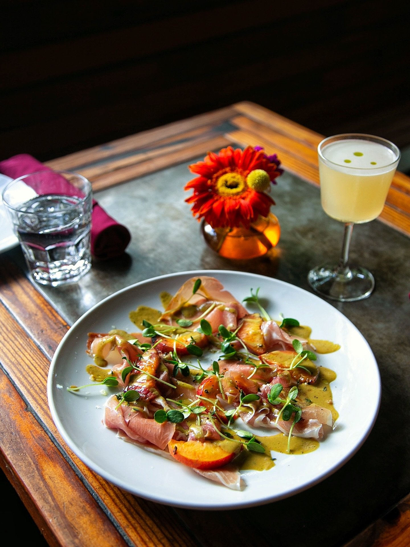new feature antipasti on the menu tonight: prosciutto &amp; grilled peaches 🍑✨ served with a balsamic peach vinaigrette, cantaloupe greens, fresh thyme, sea salt &amp; pepper. pairs beautifully with our prosciutto e melone&mdash;come try the duo! 🥂