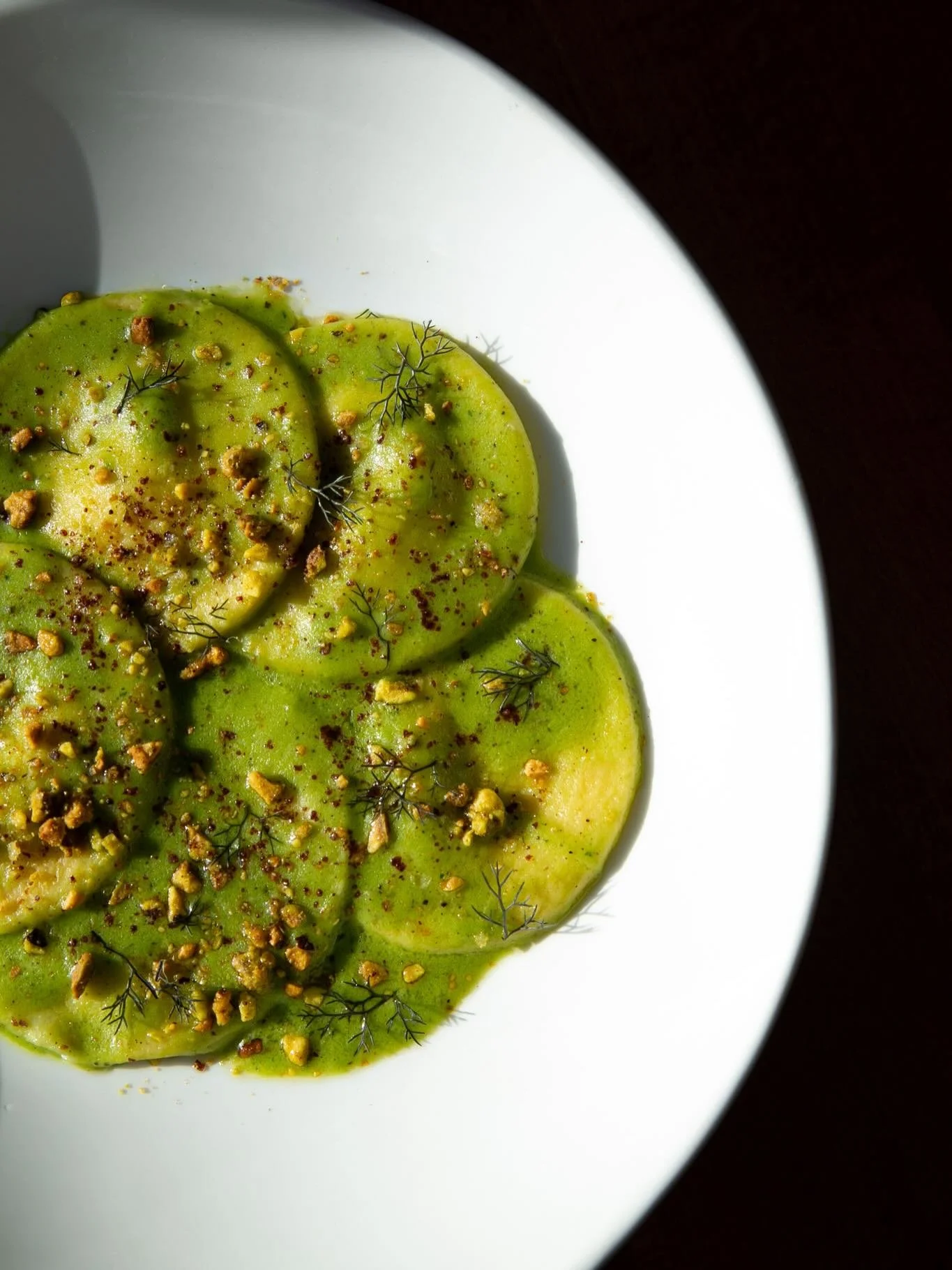 primi feature tonight: goat cheese ravioli with peas, mint, fennel, sumac, and pistachio. ✨