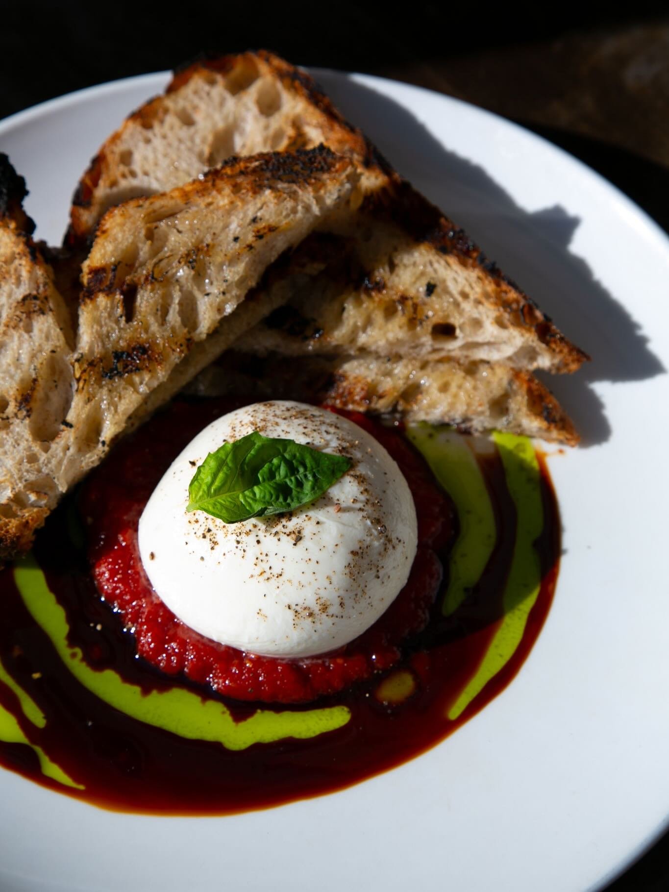 burrata 💛

an a mano classic &mdash; creamy burrata served with balsamic reduction, house tomato jam, basil oil, smoked sea salt &amp; grilled sourdough. 🍅🥖