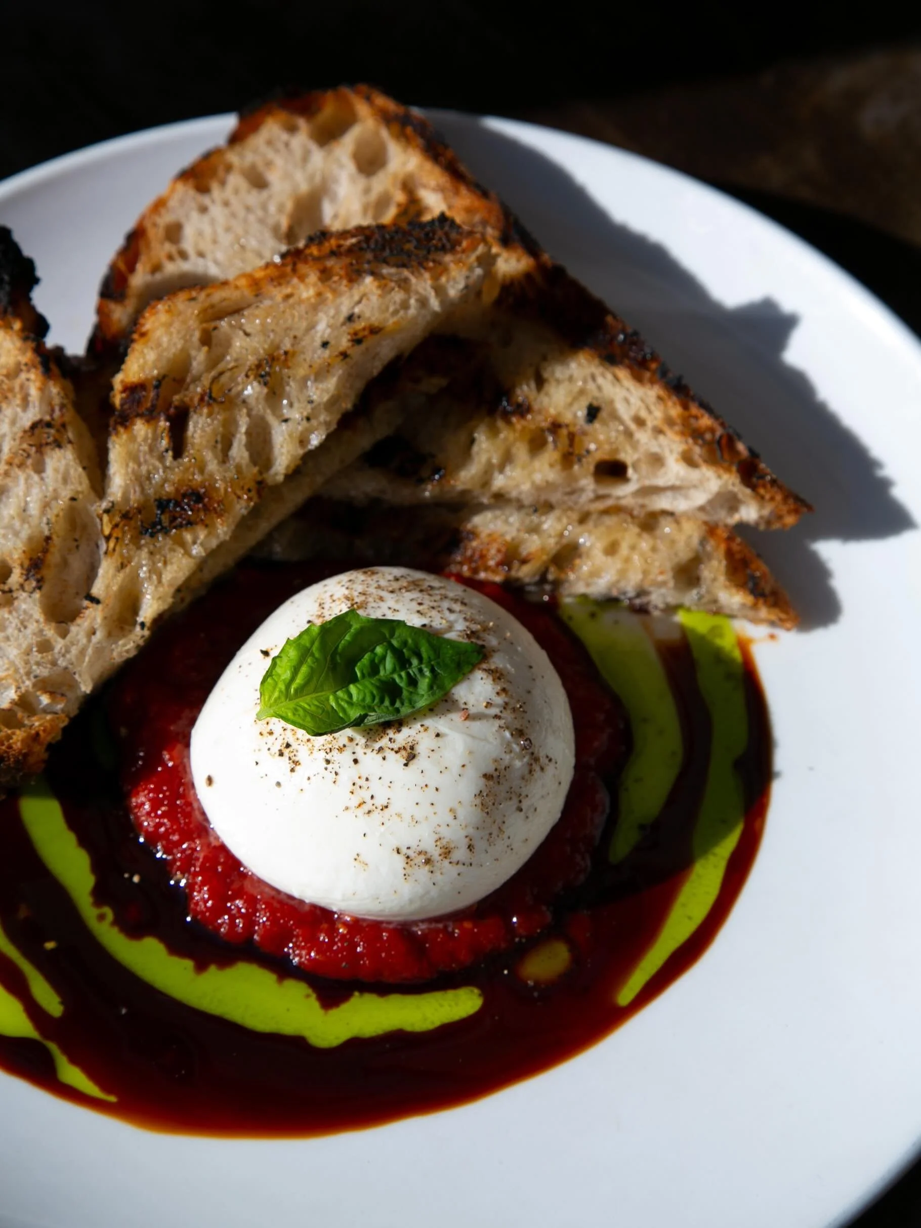 ✨Burrata ✨ Our beloved signature dish, celebrated by guests and staff alike. 

This luxuriously creamy burrata is complemented by our sweet tomato jam, fragrant basil oil, and a refined balsamic reduction, creating an elegant harmony of richness, fre