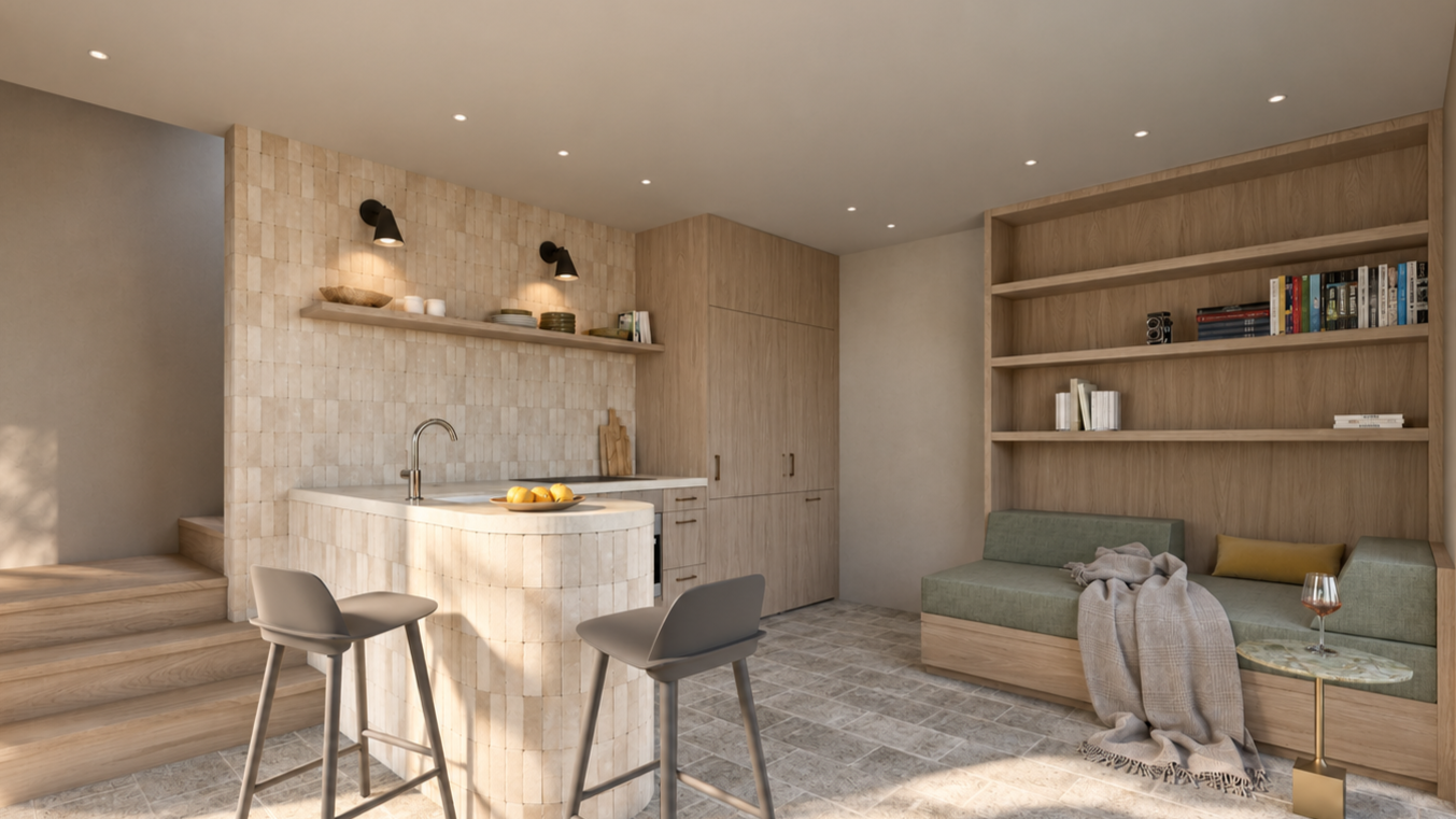 Modern kitchen with beige tiled breakfast bar, open wooden shelving with dishes and bowls, and a built-in wooden cabinet. There are two gray chairs at the breakfast bar, a bowl of apples on the counter, and a gray sofa with a blanket and pillow in the background.