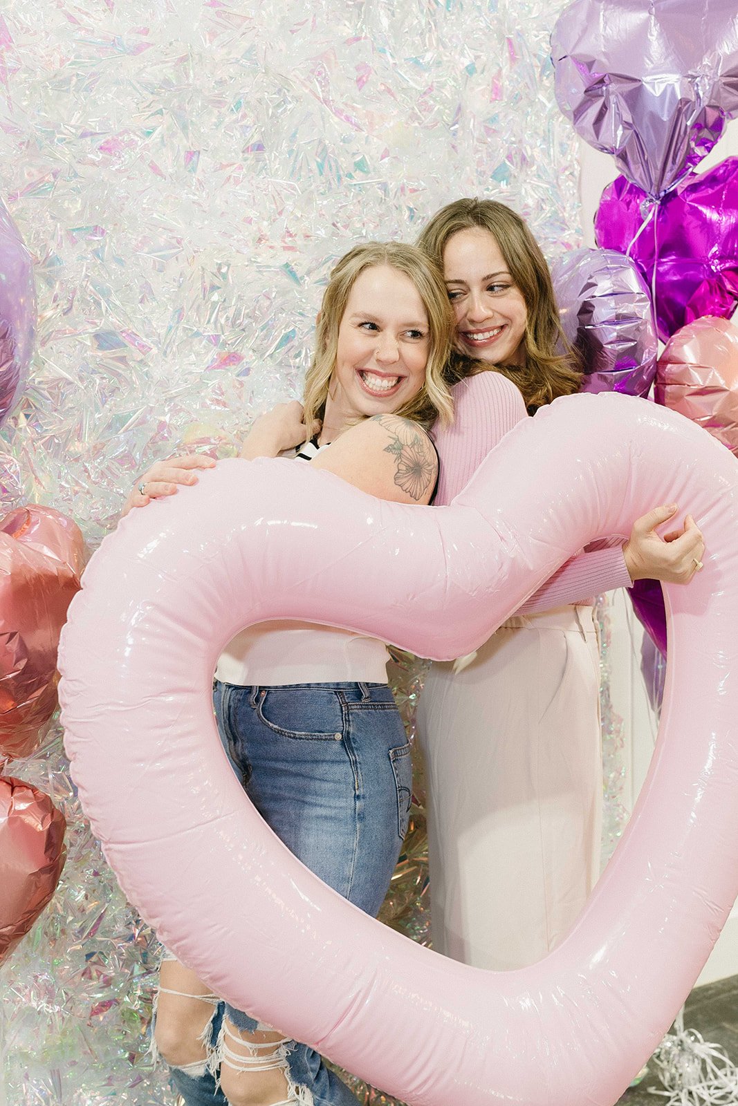Women posing for a photo booth at a social girl party