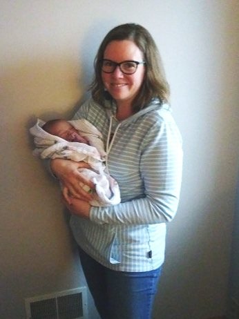 Doula Duchess Emily Lindgren holding Jamie's baby