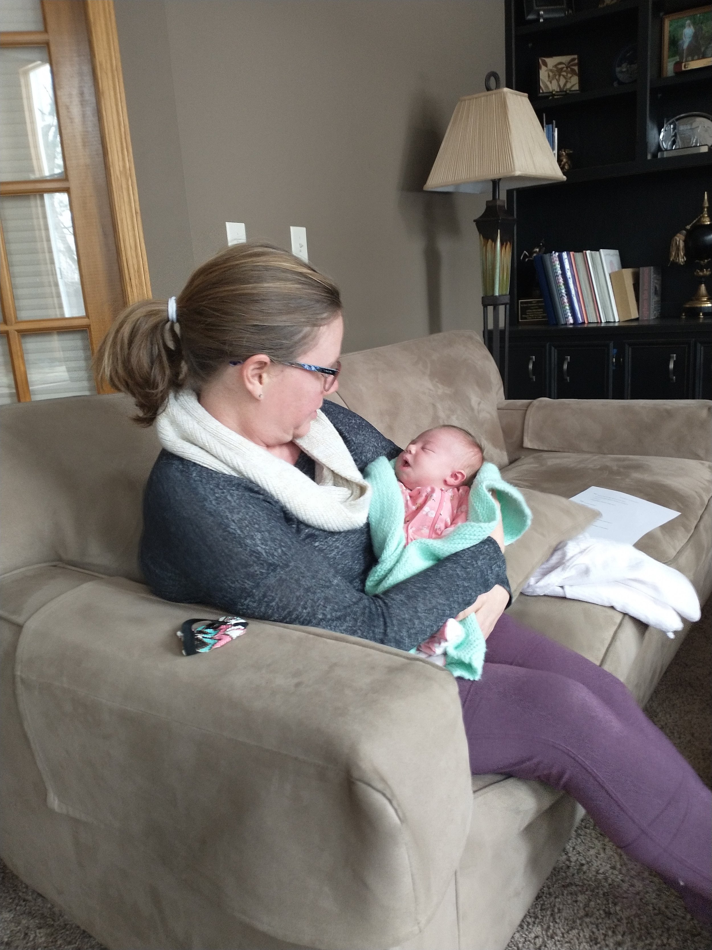 Doula Emily holding Aleah's baby
