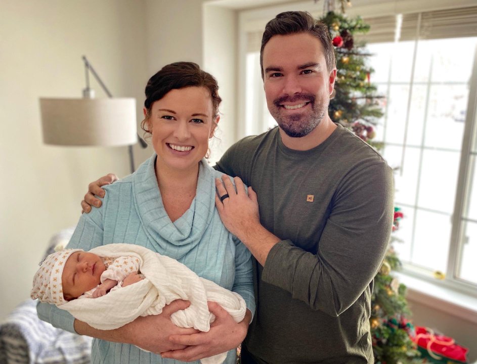 Marni P. and her husband with new baby