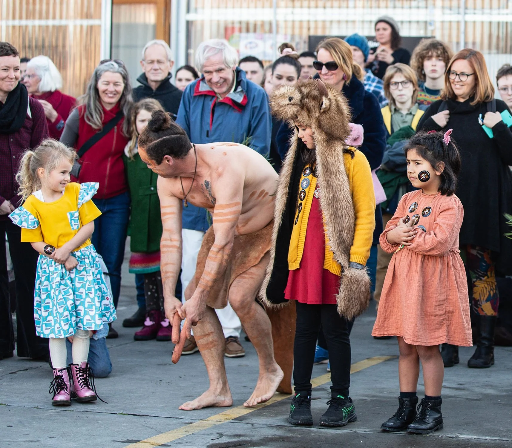 Indigenous man performing traditional ceremony with children