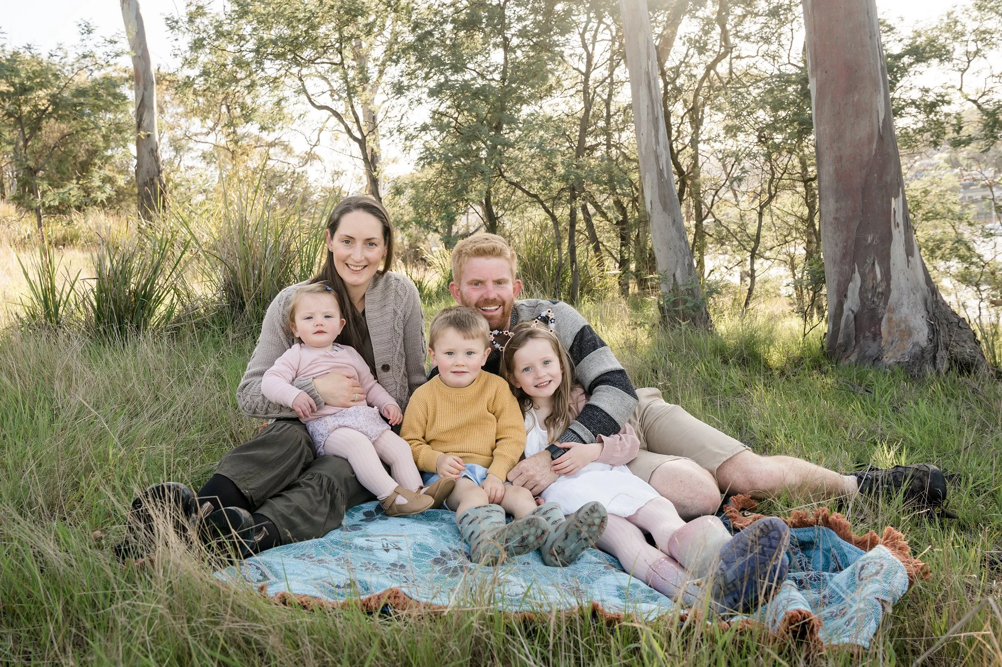 Photo of Hobart family on rug looking happy