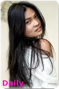 Pattaya outcall escort Daily poses for the camera in a blue jean jacket, exuding confidence and charm in a erotic manner.