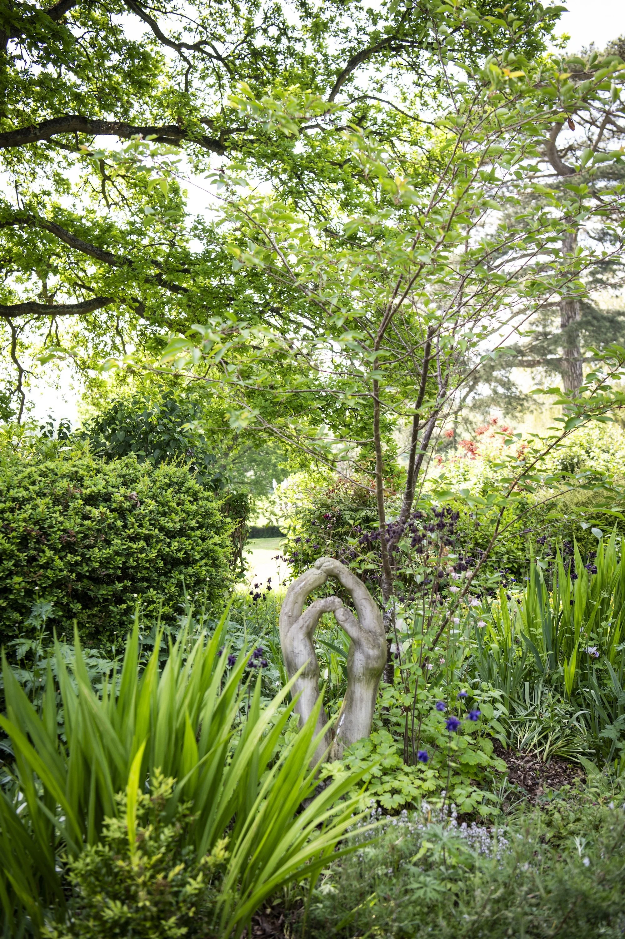 Photo of a sculpture of hands clasped together in prayer at the Kenward Trust addiction recovery prayer garden in Kent