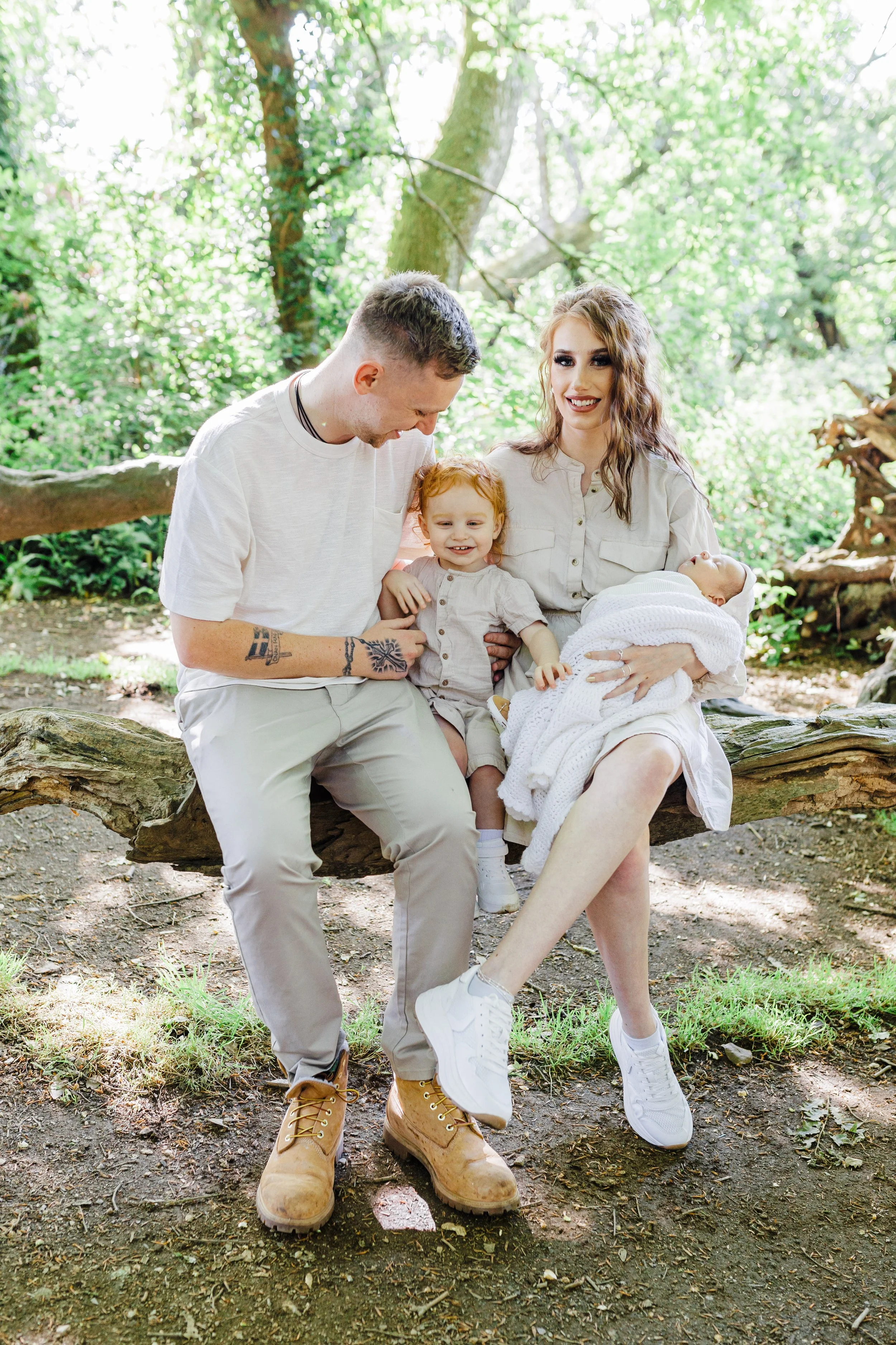 Family of four sat on a tree branch at Tehidy Woods