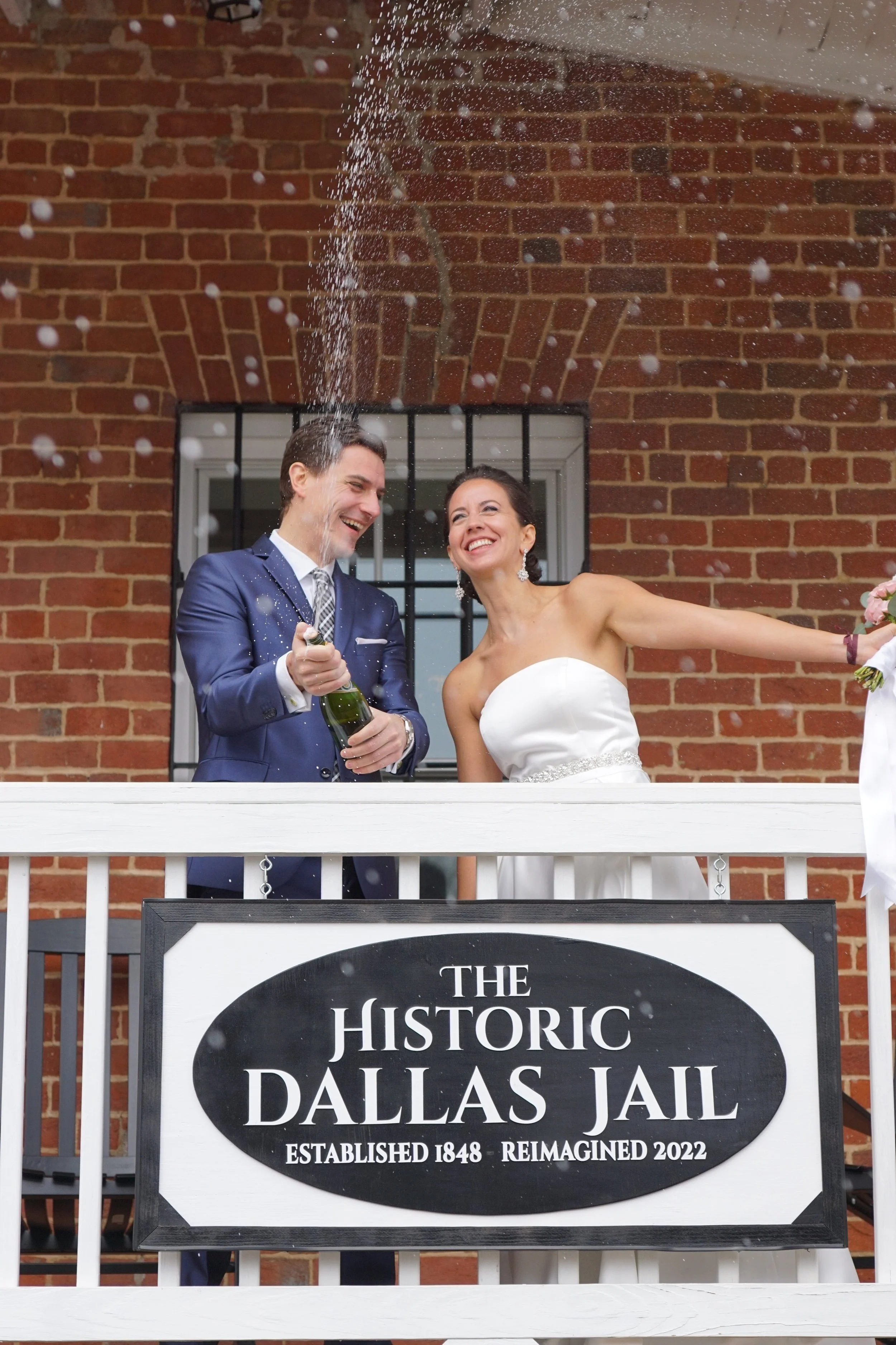 The Historic Dallas Jail Real Couple Champagne Spray.JPG