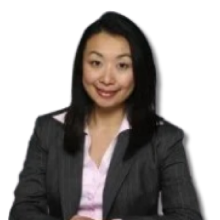 Professional woman with black hair wearing a dark blazer and pink blouse, smiling and seated against a plain light background.