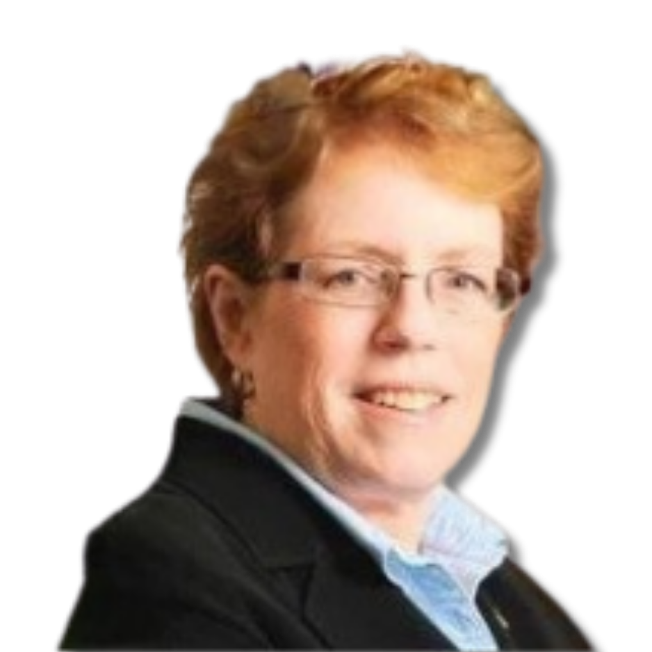 A portrait of a smiling woman with short, curly, reddish hair, wearing glasses, a black blazer, and a blue shirt.