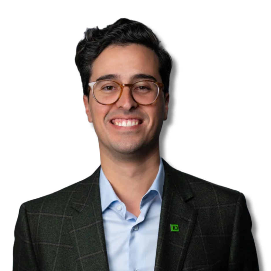 A smiling man wearing glasses, a dark checkered blazer, and a light blue shirt, standing against a dark gray background.