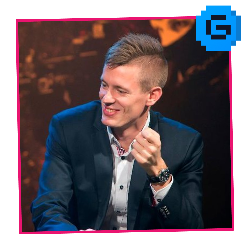 Frederik Byskov. Co-founder of Astralis. A man in a suit smiling and talking during a televised event or interview.