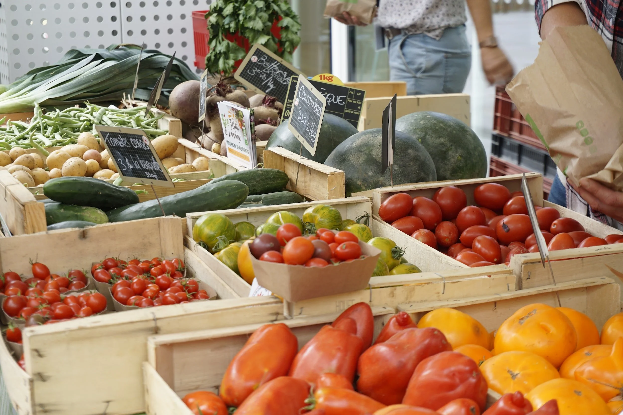 Wooden crates of produce with chalkboard signs