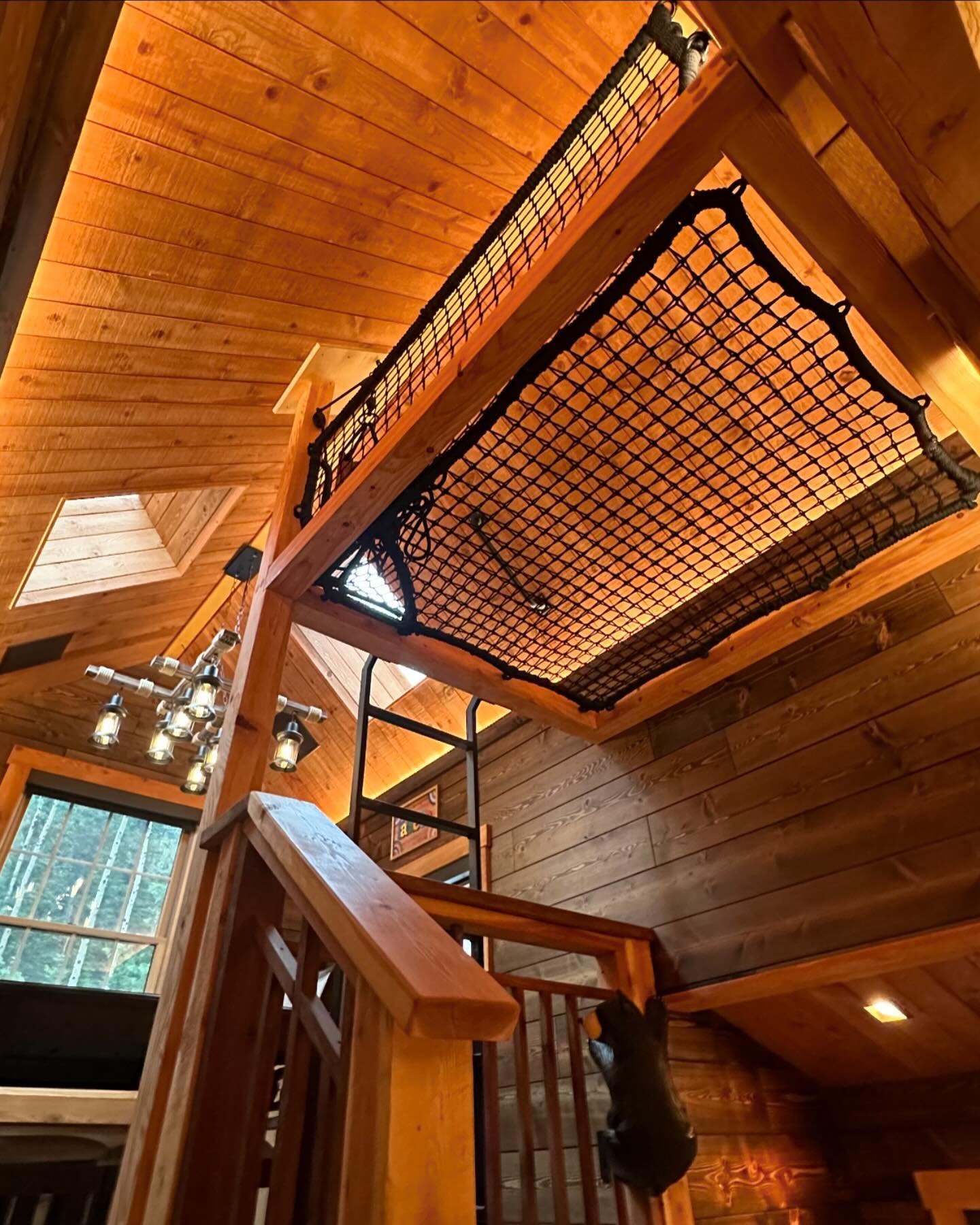 The latest and greatest addition to our Black Hawk project!  Our client @ultimatecabinexperience had us back to build this cozy little net loft in the uppermost gable of the cabin.  Accessed from the &ldquo;game room&rdquo; loft from a custom steel l