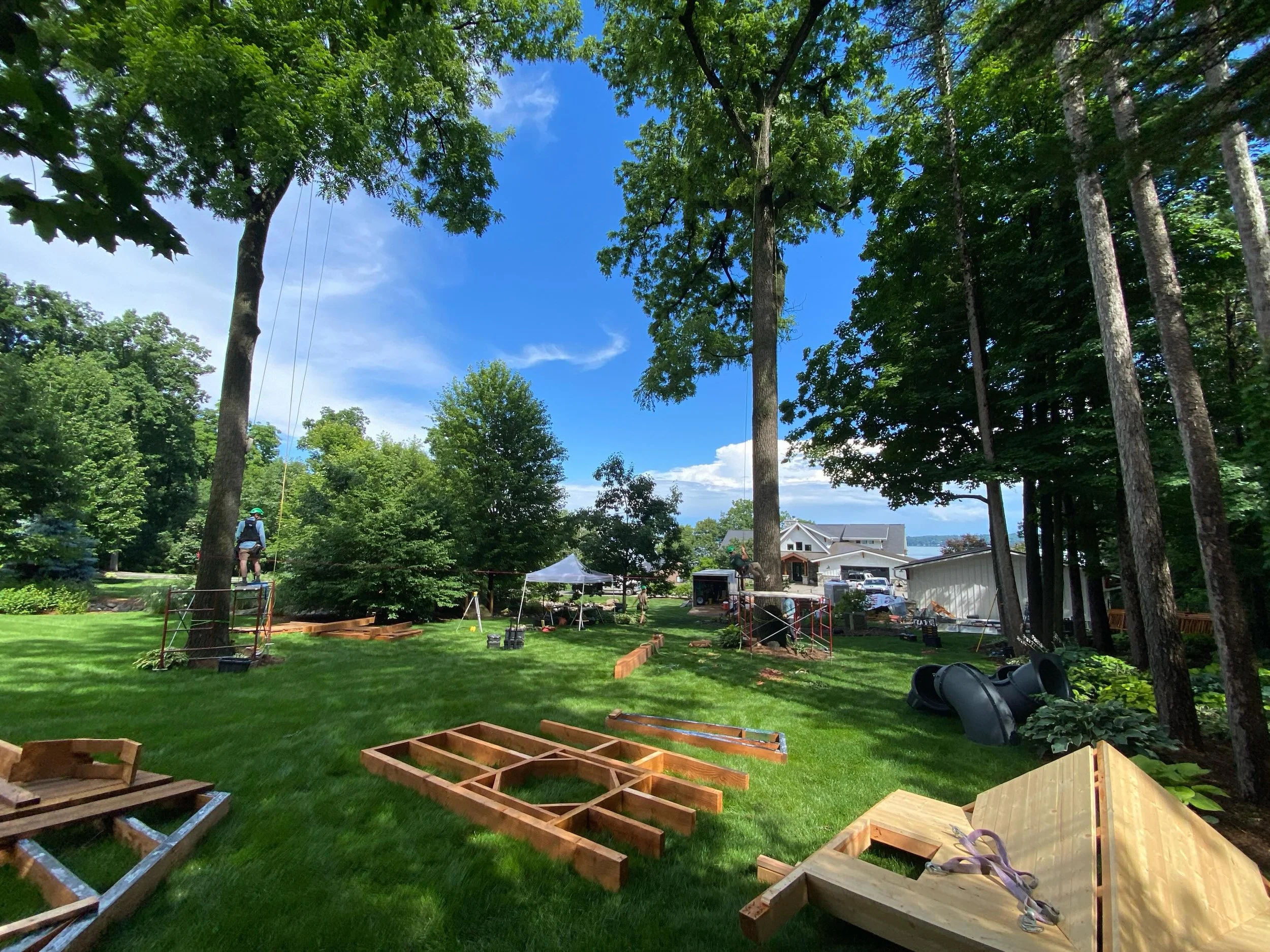 More Day 1 activity on the Mendota Treehouse raising.  Rained off and on today but we got the trailer completely unloaded, and now there are piles of walls, roof sections, railings, lumber, etc, EVERYWHERE.  We got some rigging up in the trees and se