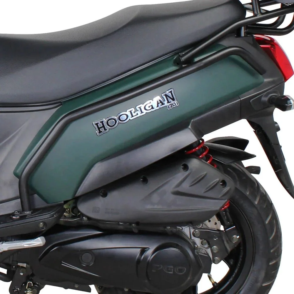 Close-up of a green and black scooter with a seat, a rear wheel, red suspension spring, and a side badge that says 'Hooligan 110'.