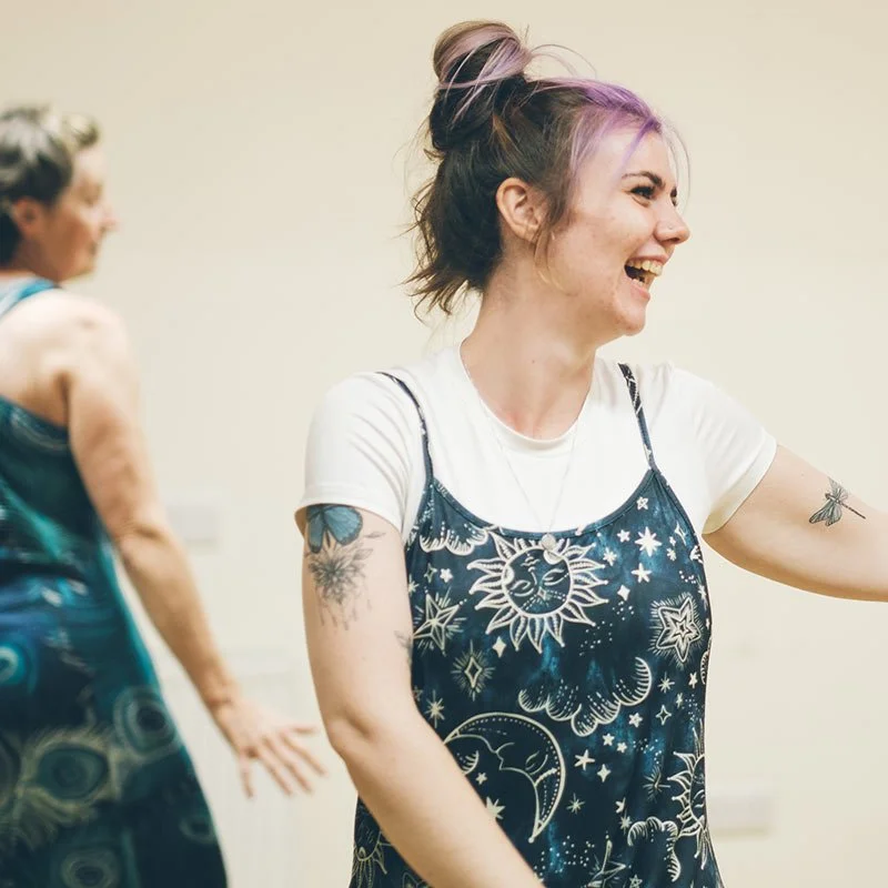 Women laughing and dancing together in a weekly Groove class.