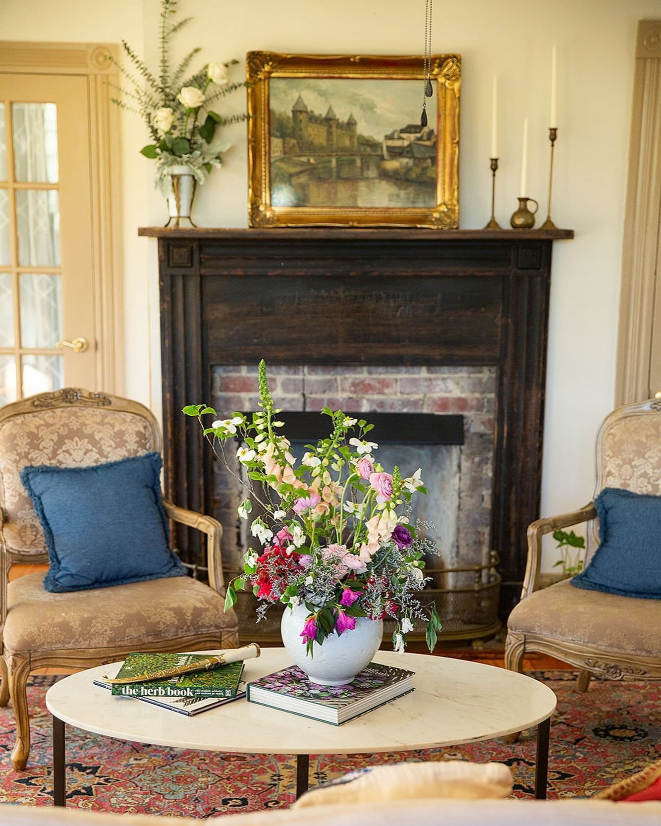 #edgewoodfarmhouse 1910
Pictured: One of eight fireplaces in the house. Still actively used. Original mantel and brick is still in tack. 
#artwork sourced in an #antiqueshop in Germany.
📸 @mollietobiasphotography 
#lazyfoxlavenderfarm #cameronnc #mo