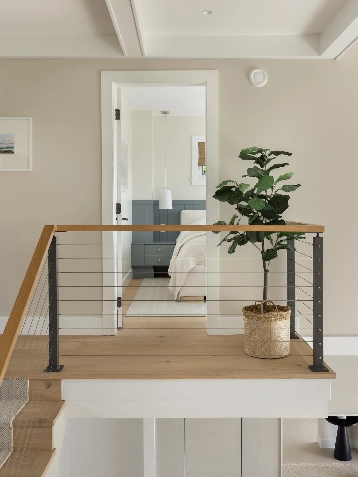 Incorporating contemporary elements into this home was an important part of the design brief. The clients knew they wanted a cable railing for the mezzanine level, but we opted for off-black posts and a white oak hand rail to soften the look and keep
