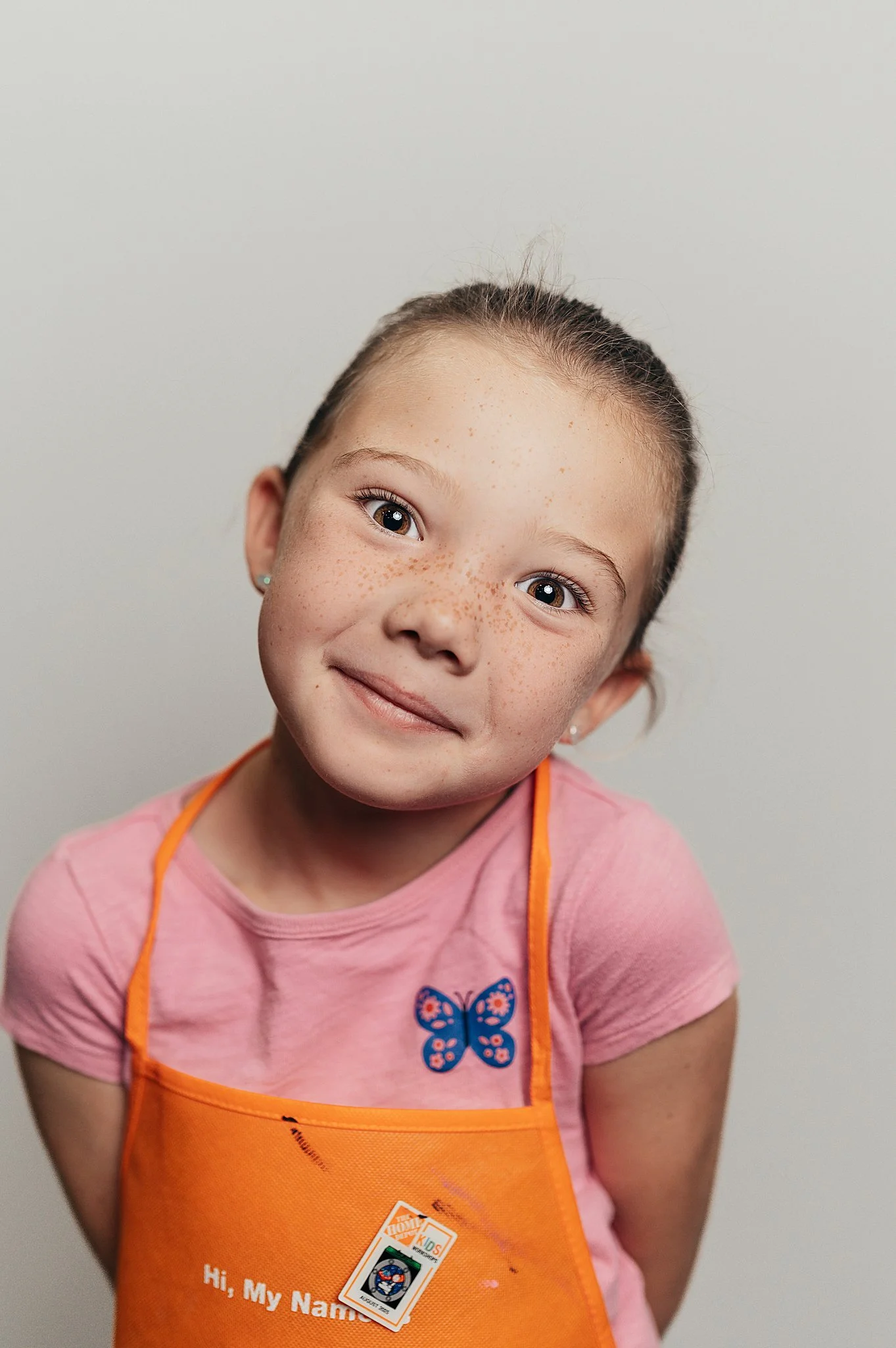 Fine art school portrait of a girl with a Home Depot apron on.