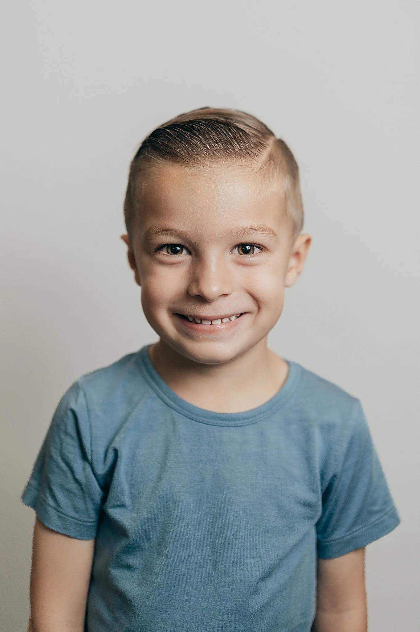 preschool portrait with boy in a blue shirt.