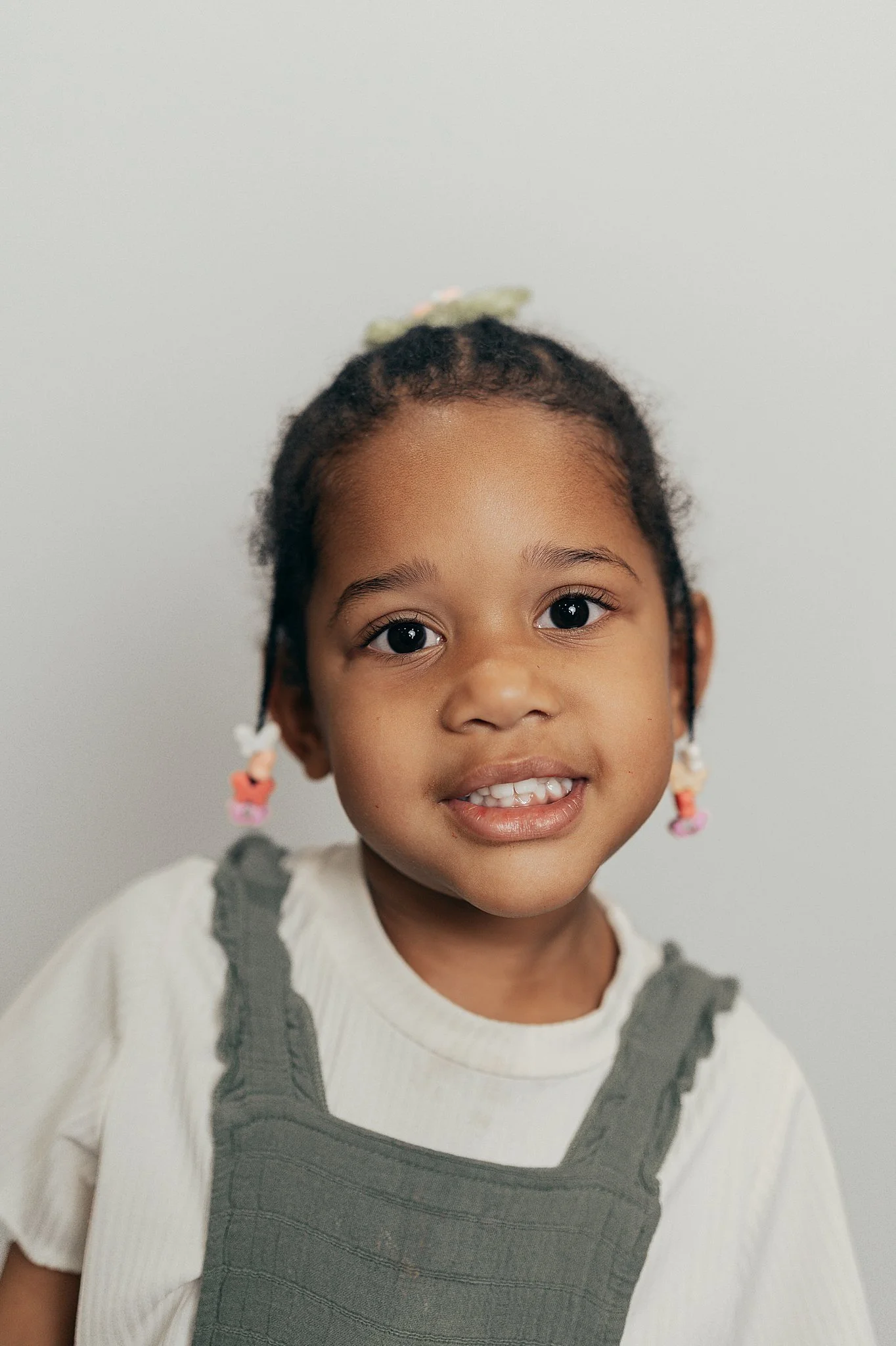 preschool portrait with girl in pink earrings.