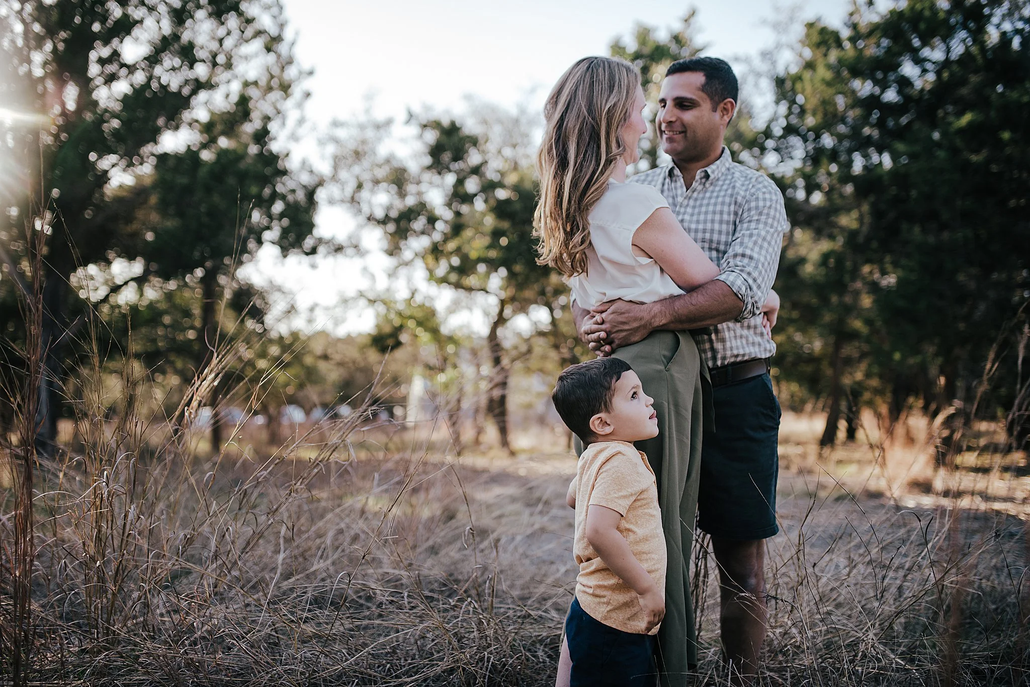 Family golden hour session. Texas Hill country. Las Vegas family. Mom in olive skirt with olive top. Mom and dad with toddler boy.