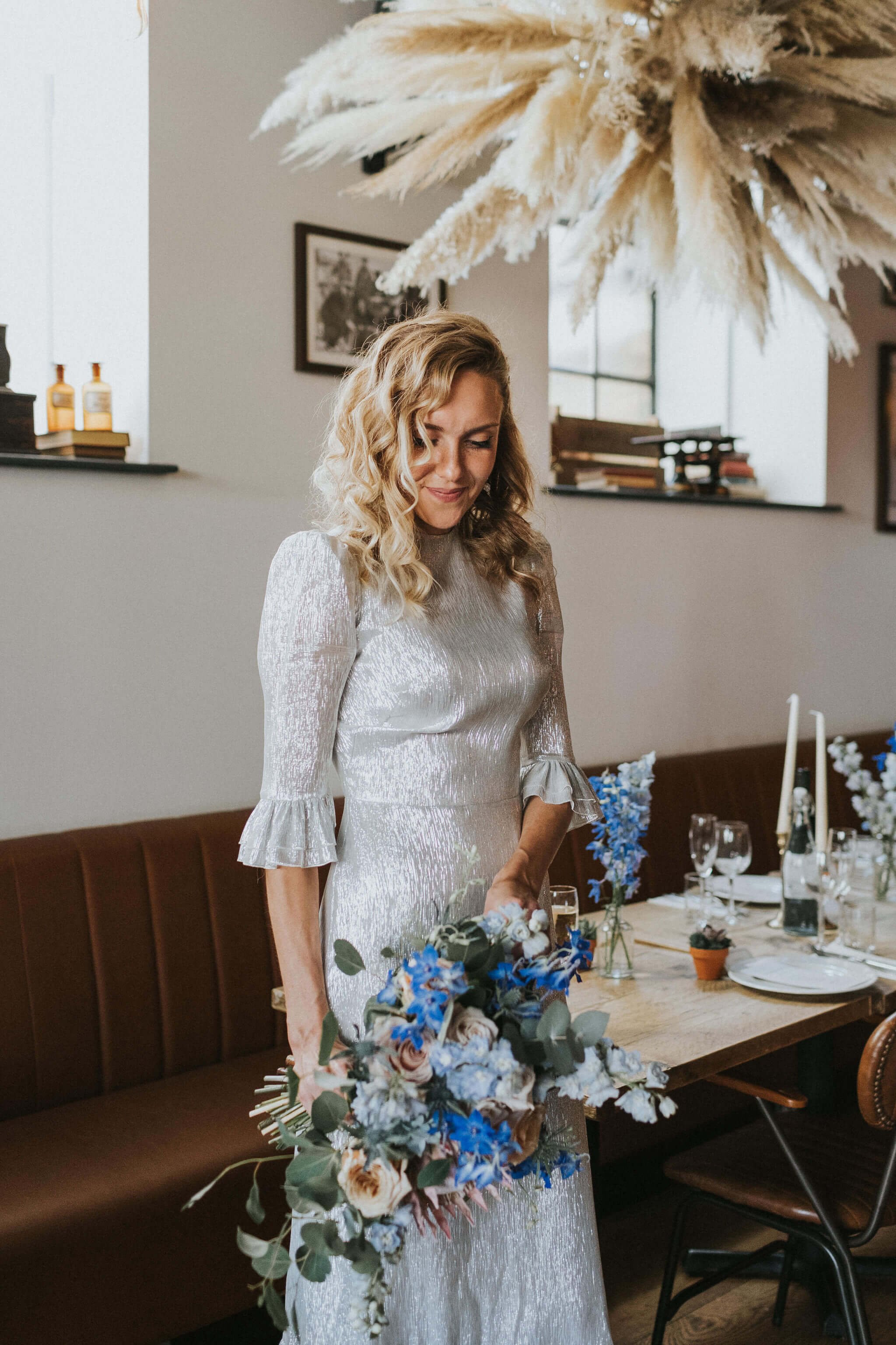 Bride-with-bouquet-in-front-of-dried-flower-cloud.jpg