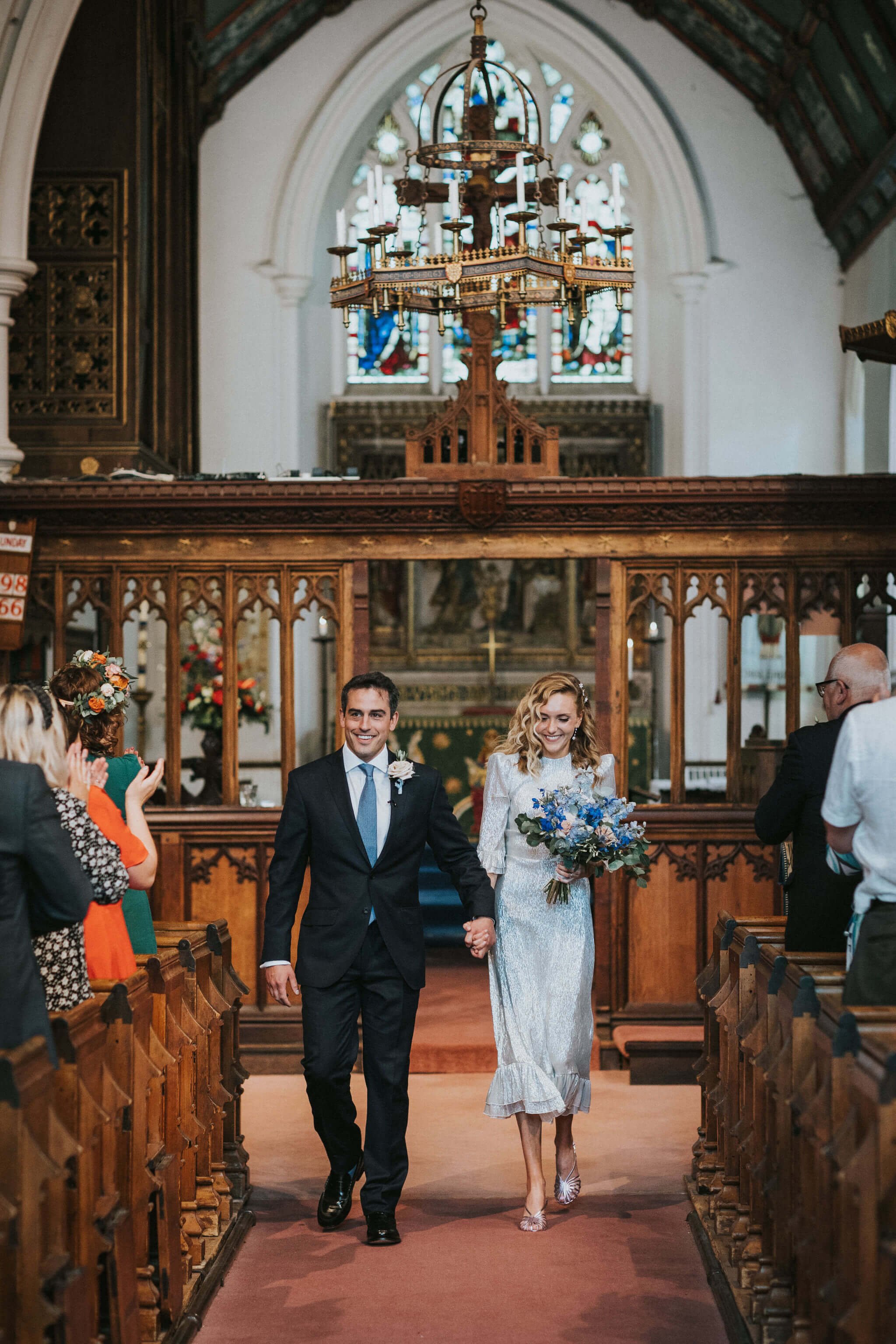 Wedding-church-exit-groom-buttonhole-bride-bouquet.jpg