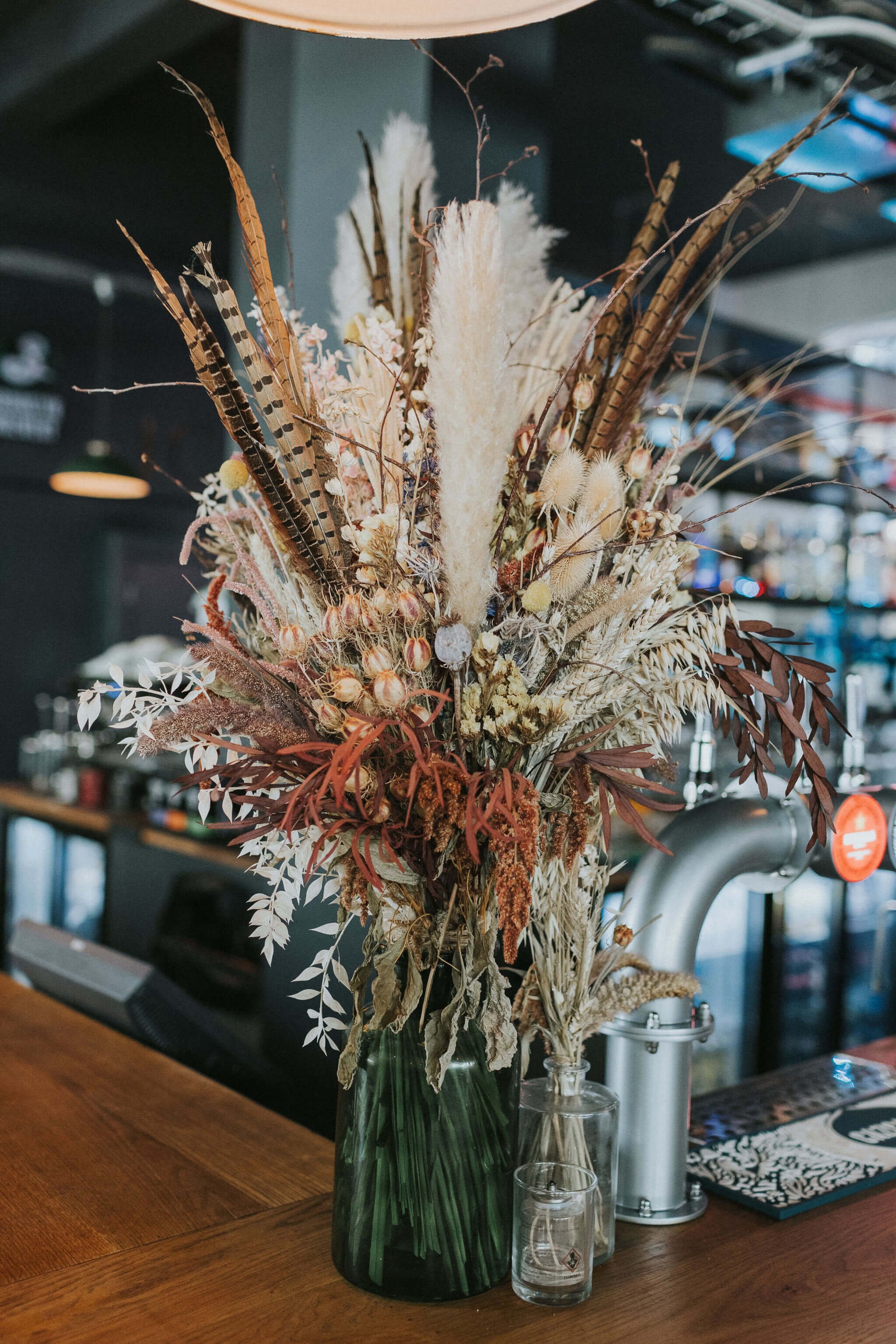 Large-dried-flower-arrangement-in-transparent-vase.jpg