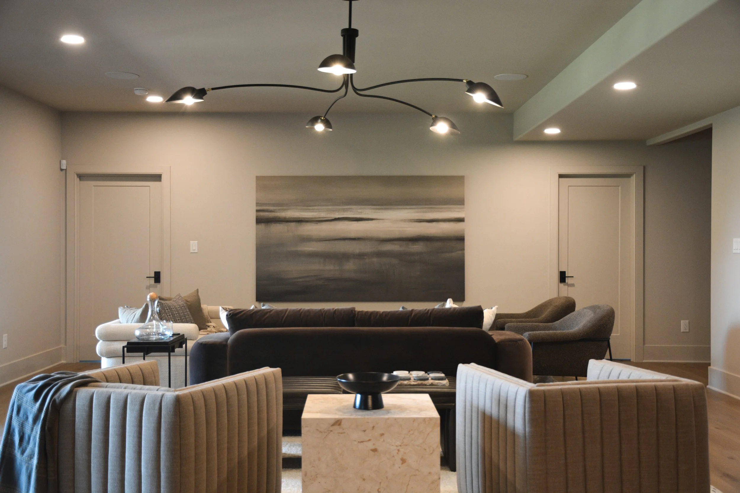 Wide Basement Lounge View with Statement Lighting.jpg
