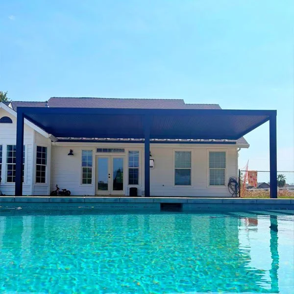 A white house with a pool and a patio cover providing shade from the extreme summer heat in Redding CA