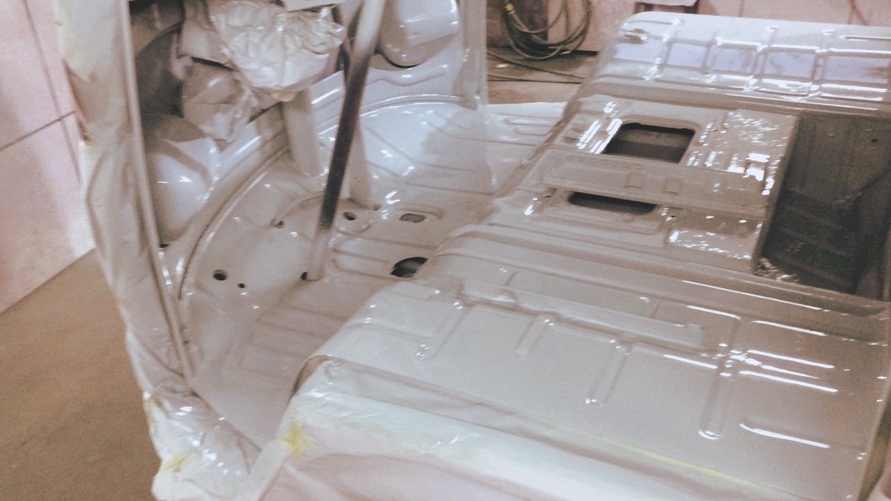 interior of a painted vehicle body shell in a workshop