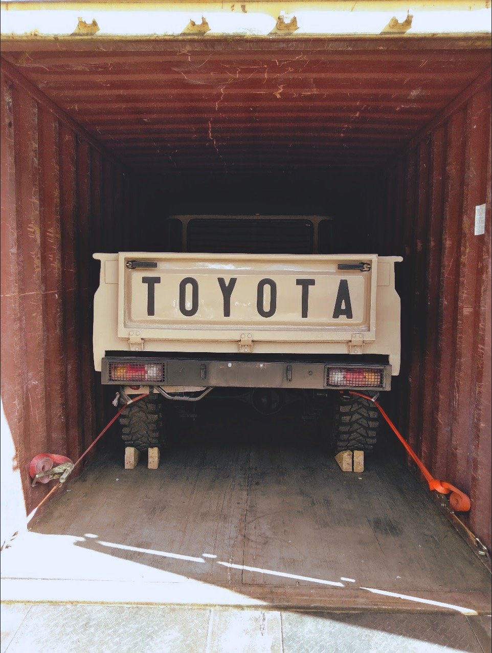 Toyota vehicle secured inside a shipping container with straps