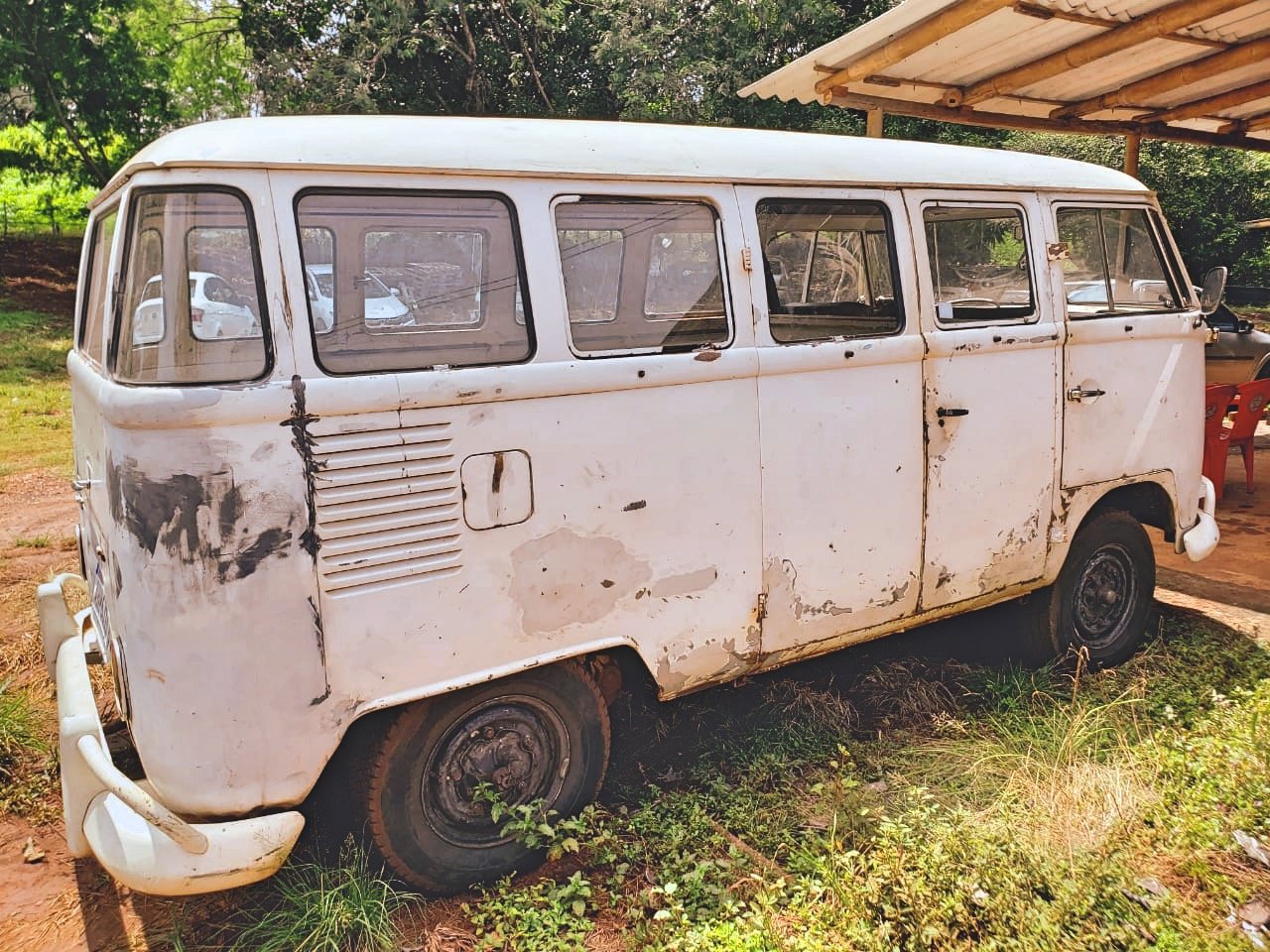 Old Volkswagen van parked outdoors with rust and damage