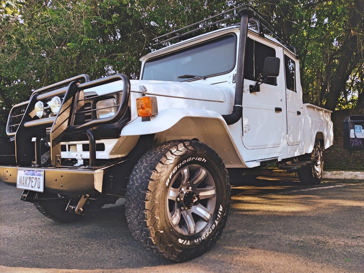 Off-road vehicle with bull bar and roof rack parked outdoors