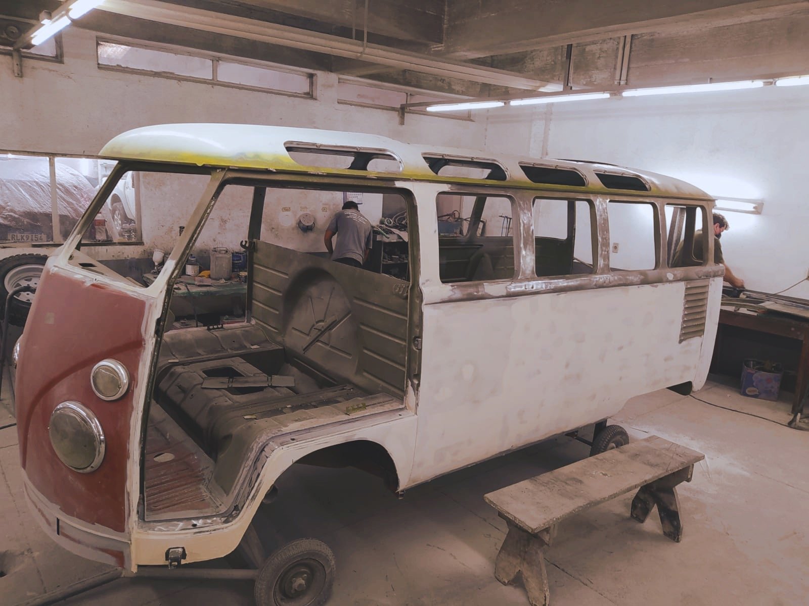 Vintage Volkswagen bus undergoing restoration in workshop