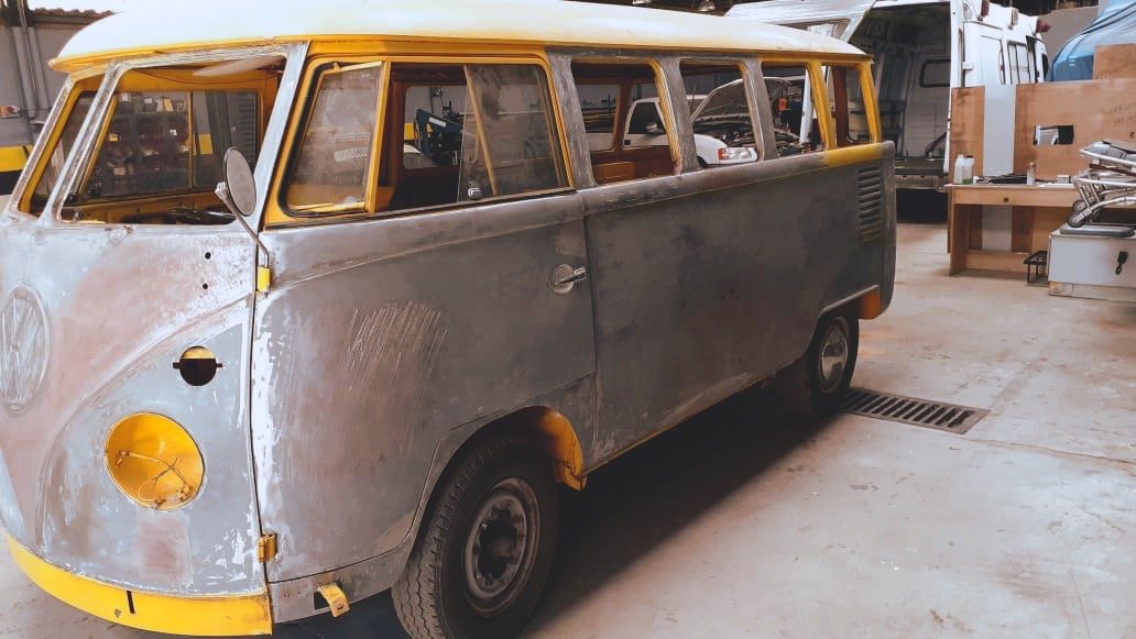 Vintage Volkswagen bus being restored in a workshop