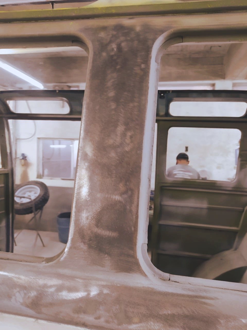 Sanded metal frame of a vintage vehicle in a workshop
