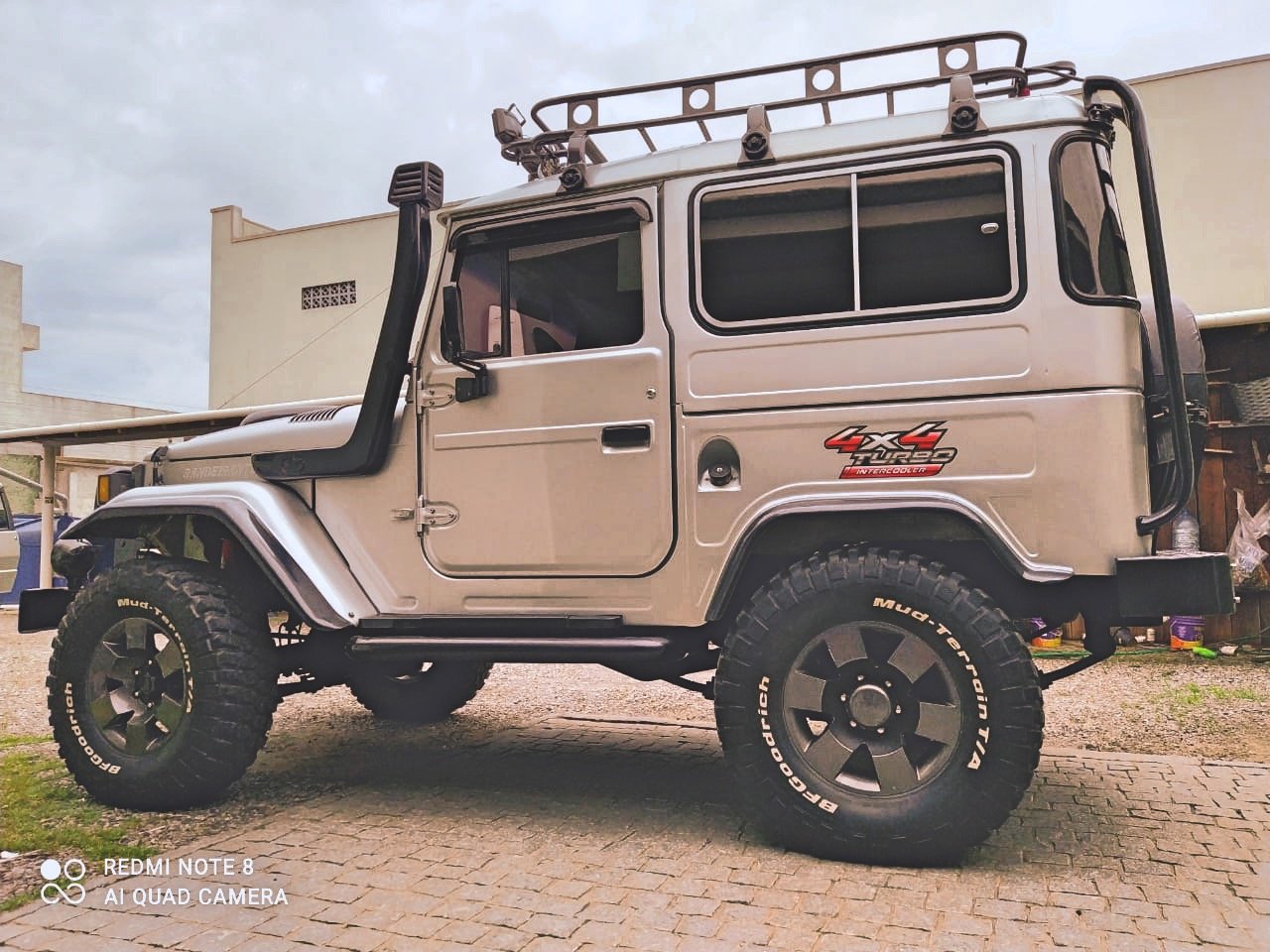 Modified off-road 4x4 vehicle with roof rack and large tires