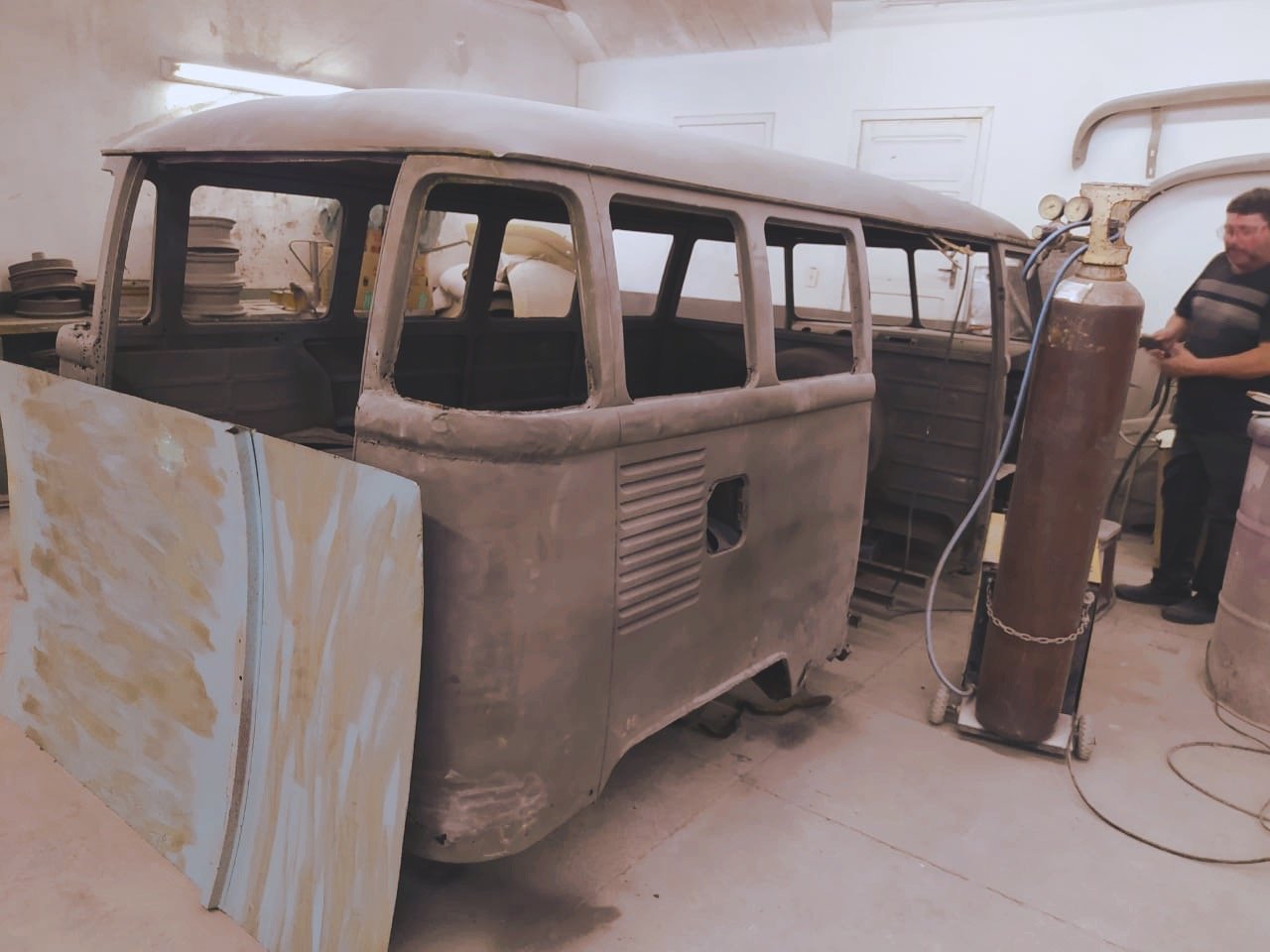 A vintage van under restoration in a workshop.
