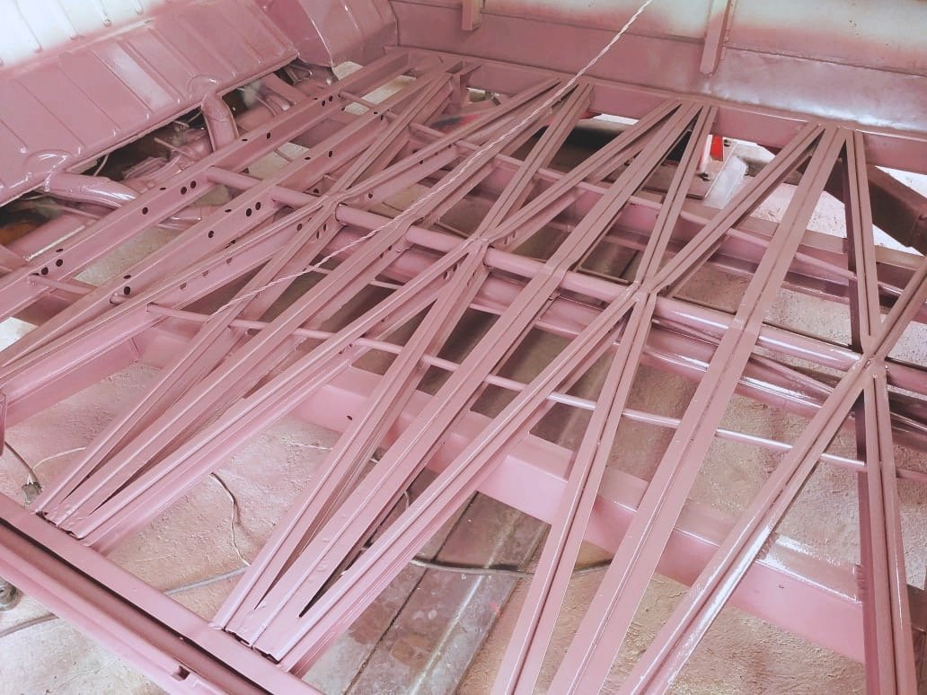 Pink painted metal frame structure with intersecting metal bars