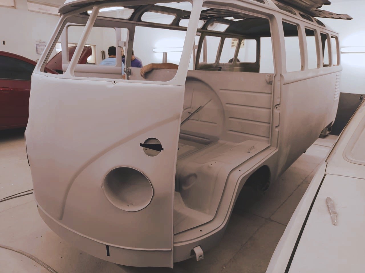 Unfinished vintage VW van restoration in a workshop