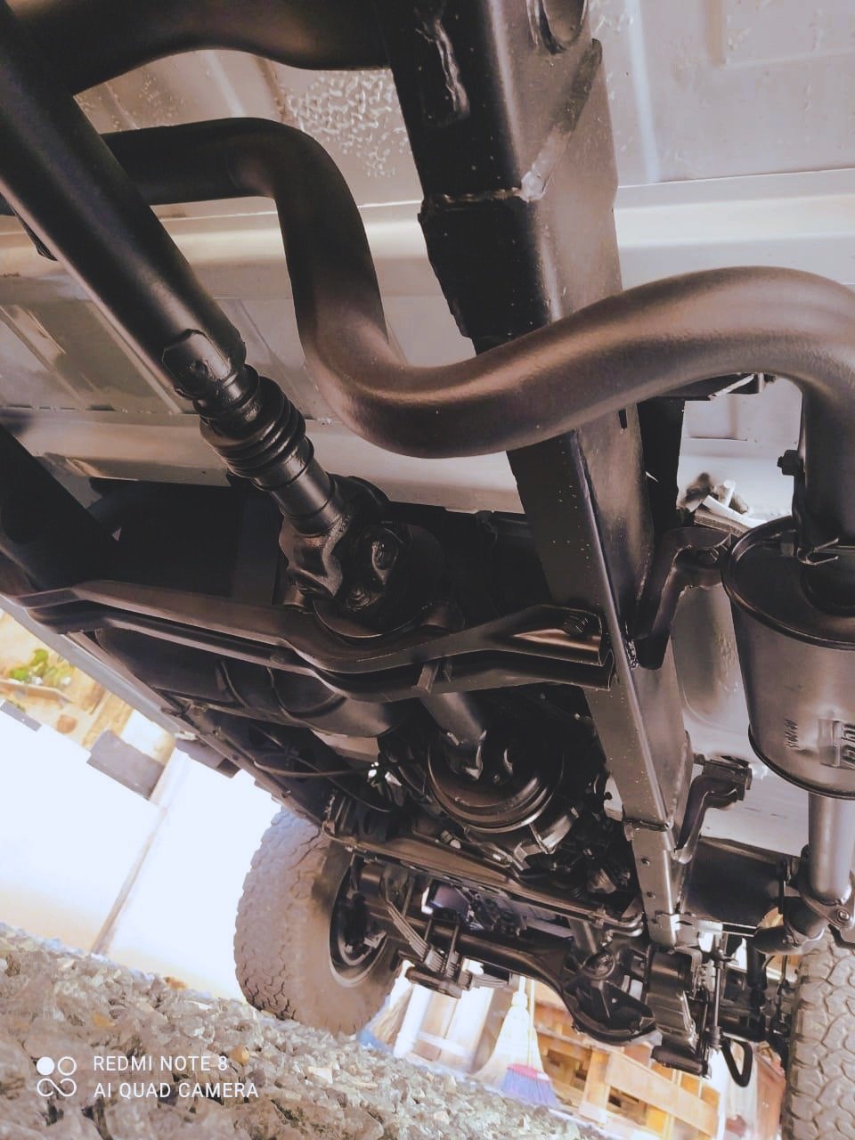 Underside view of a vehicle chassis with suspension components