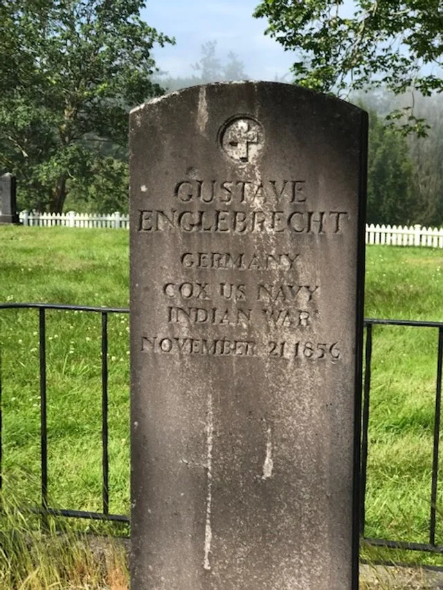  The 1856 gravestone of Gustave Engelbrecht in the Port Gamble Cemetery is among the oldest in Kitsap County. Englebrecht was a sailor aboard the USS Massachuessts and died in combat while defending Port Gamble from attacking tribesmen from British C