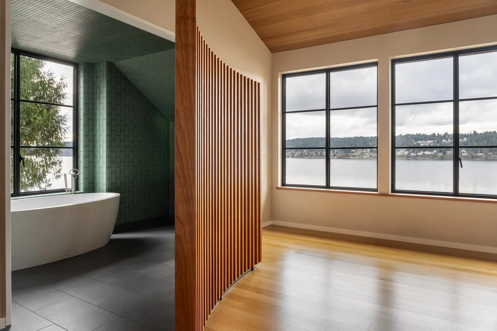 An elegant wood partition between master bath and bedroom