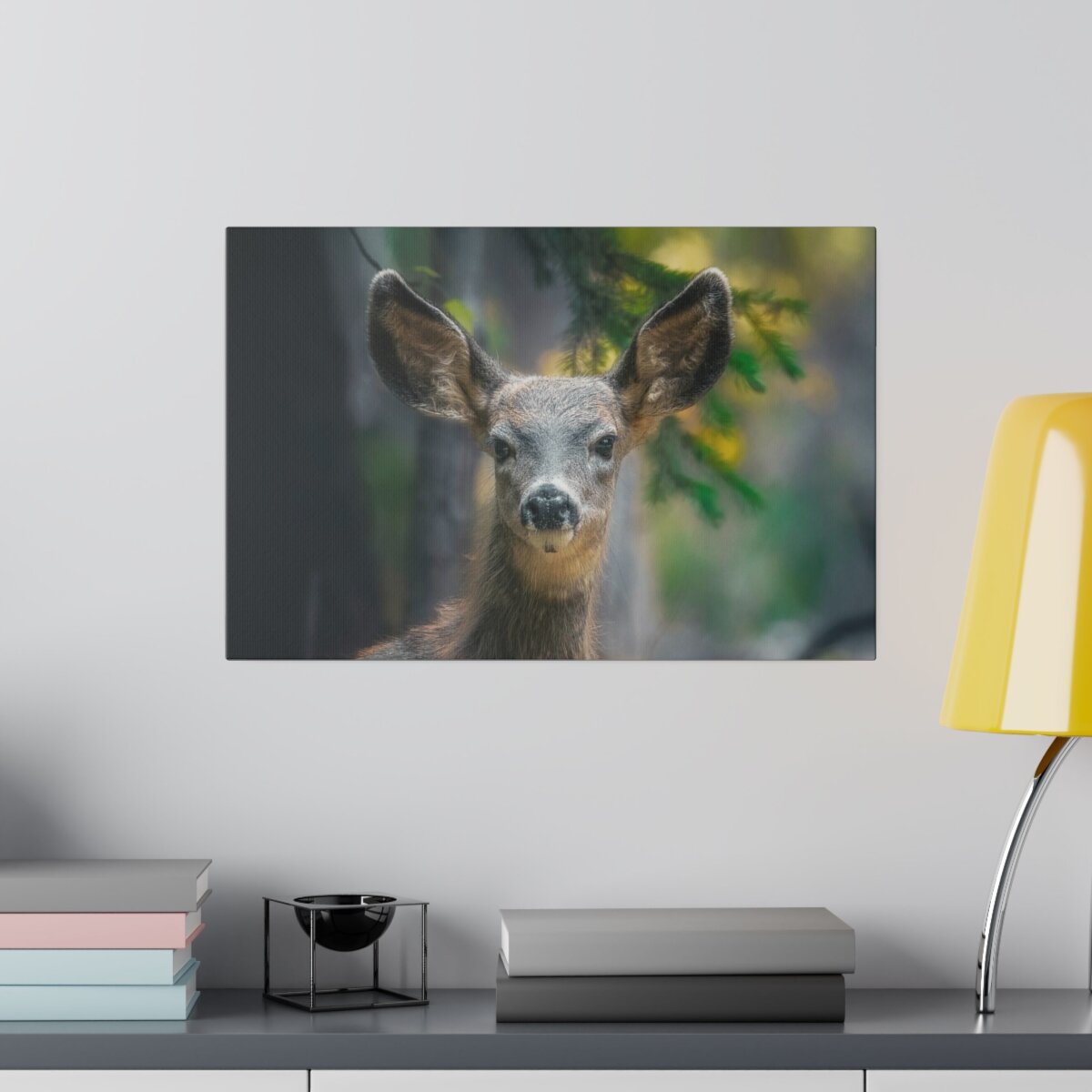 Front view of a canvas print featuring a closeup shot of an adorable, inquisitive deer fawn nestled in the forest. Premium wildlife photography wall art.